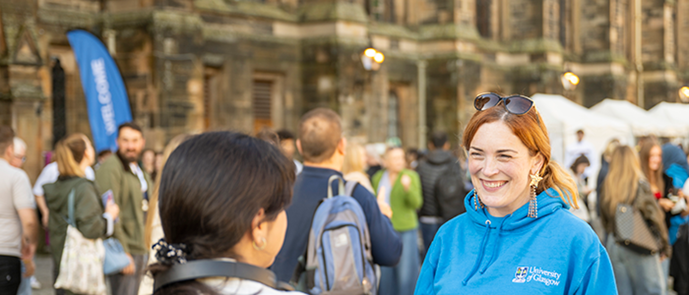 a staff member helping a student at Open Day at the Main Campus