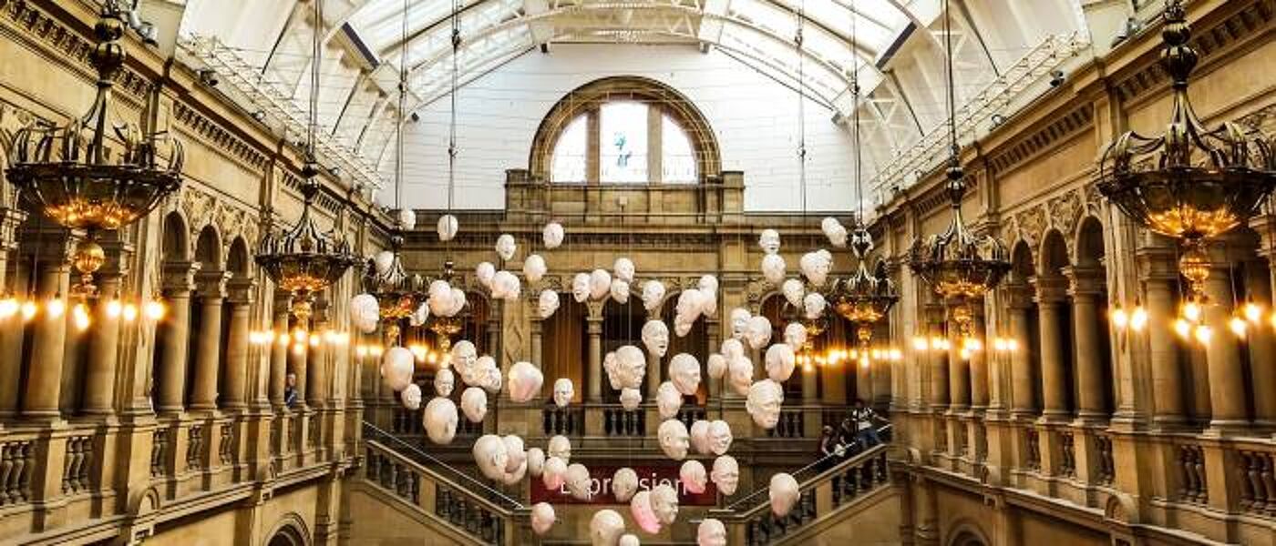 Display of hanging masks in Kelvingrove Art Gallery entrance hall